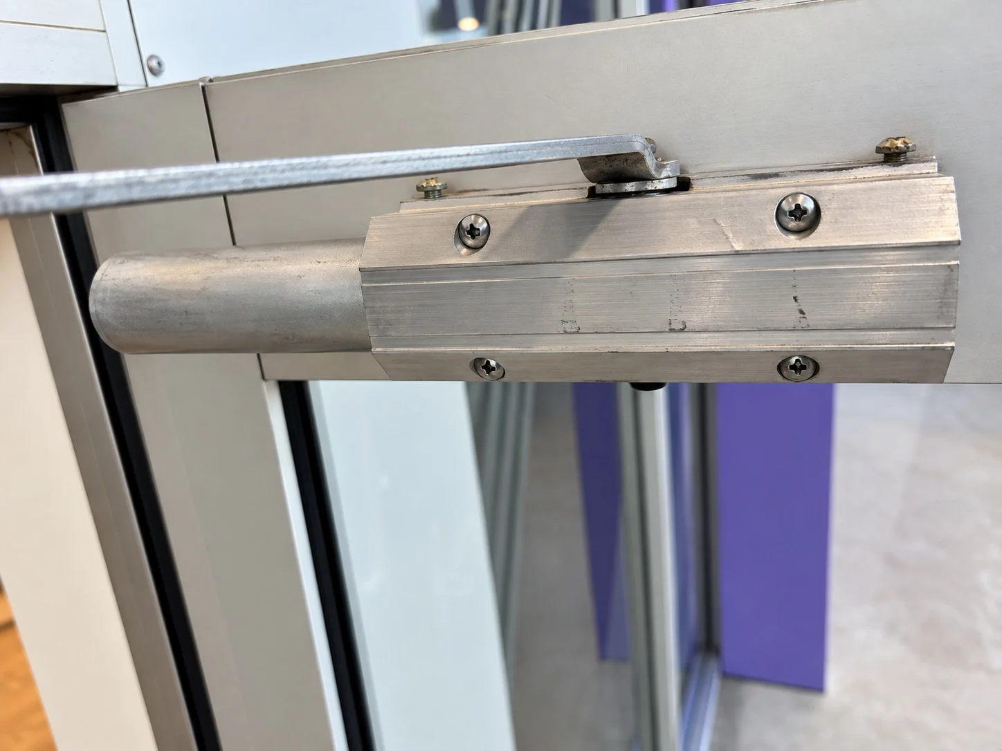Commercial door closer fitted above a doorway