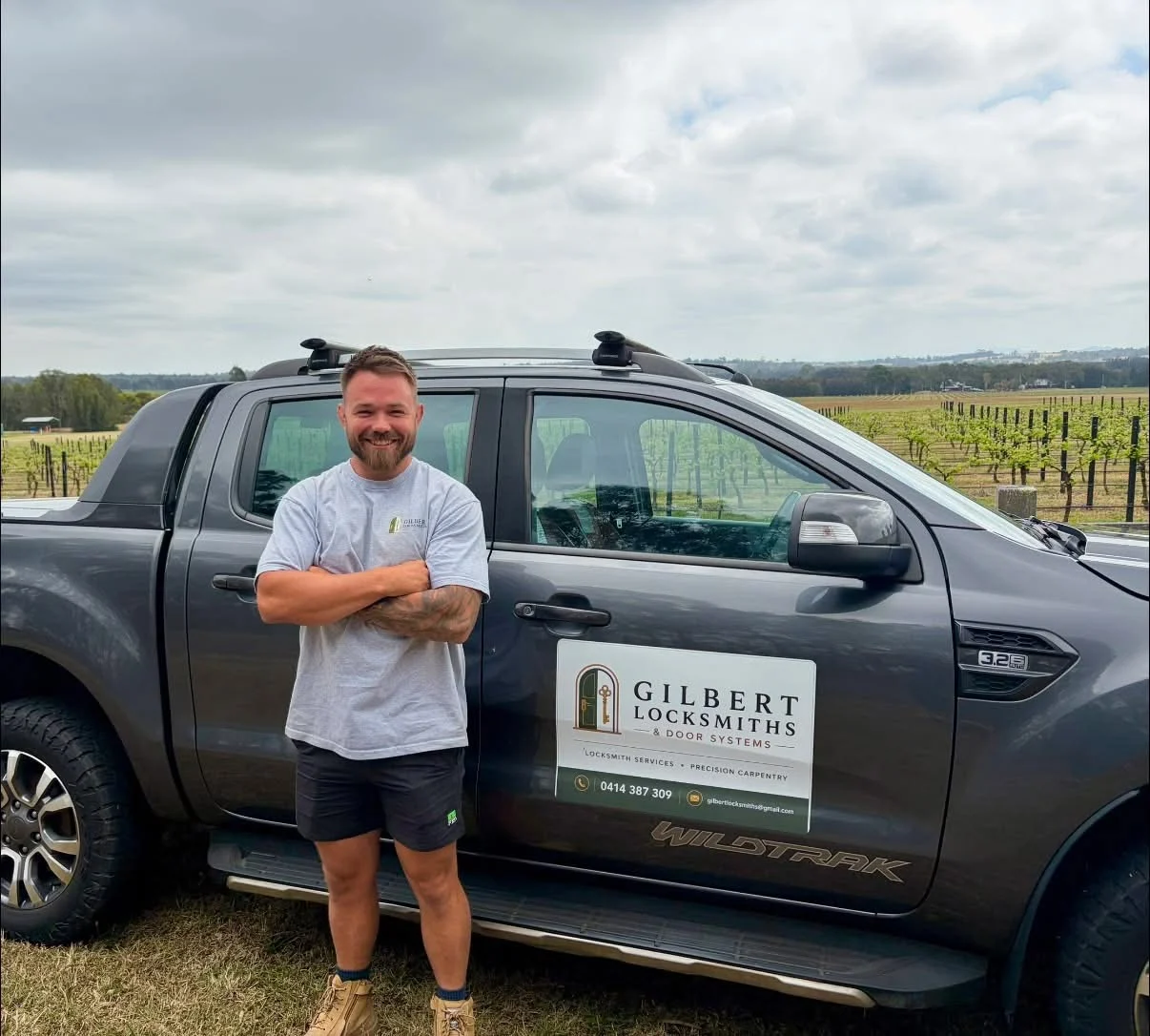Josh Gilbert standing beside his branded mobile locksmith truck